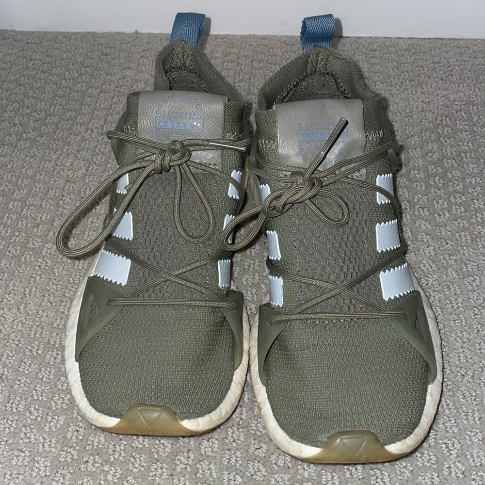 Green adidas running shoes